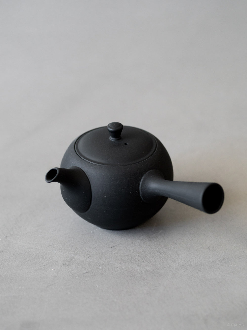 Azmaya ceramic round teapot in unglazed matte black with side handle
