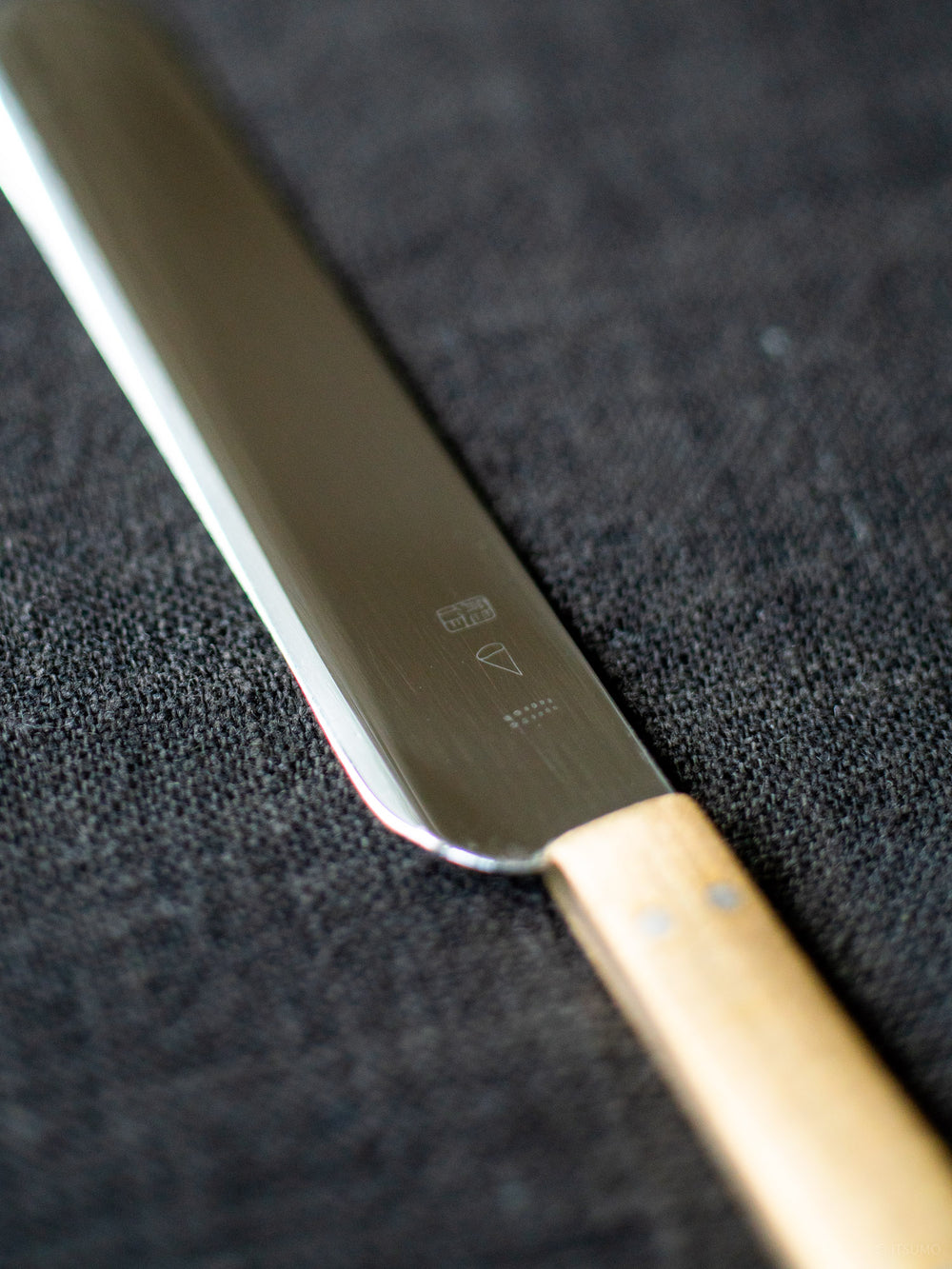 Close detail of a stainless steel butter knife made in Japan