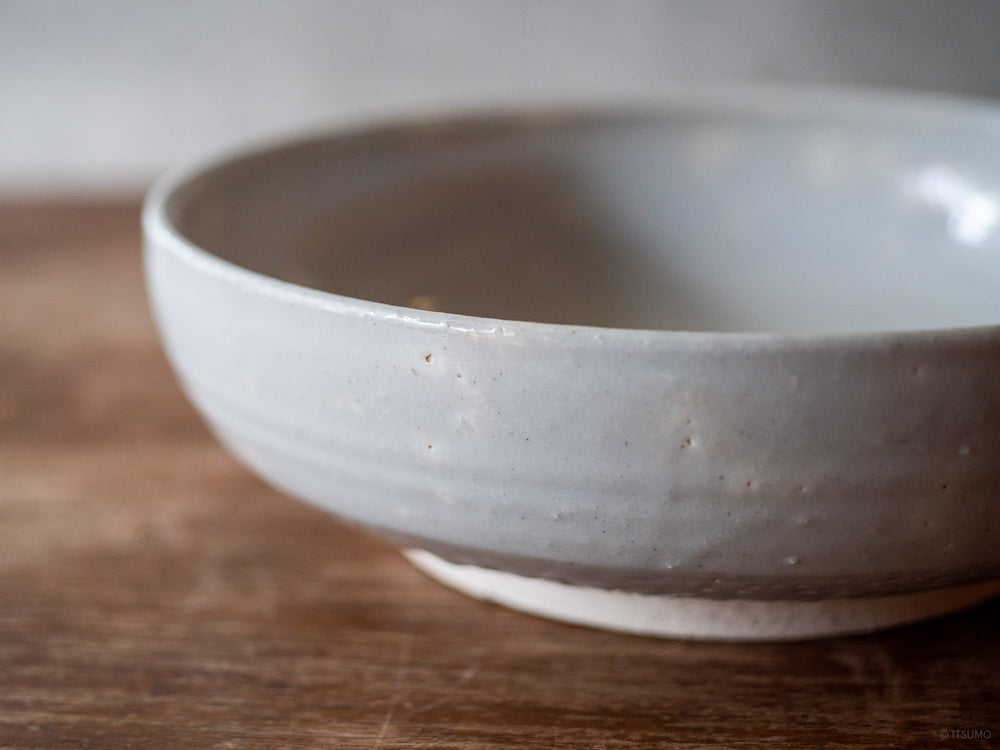 Close up detail of Azmaya's large ceramic serving bowl, in white glaze with a textured surface