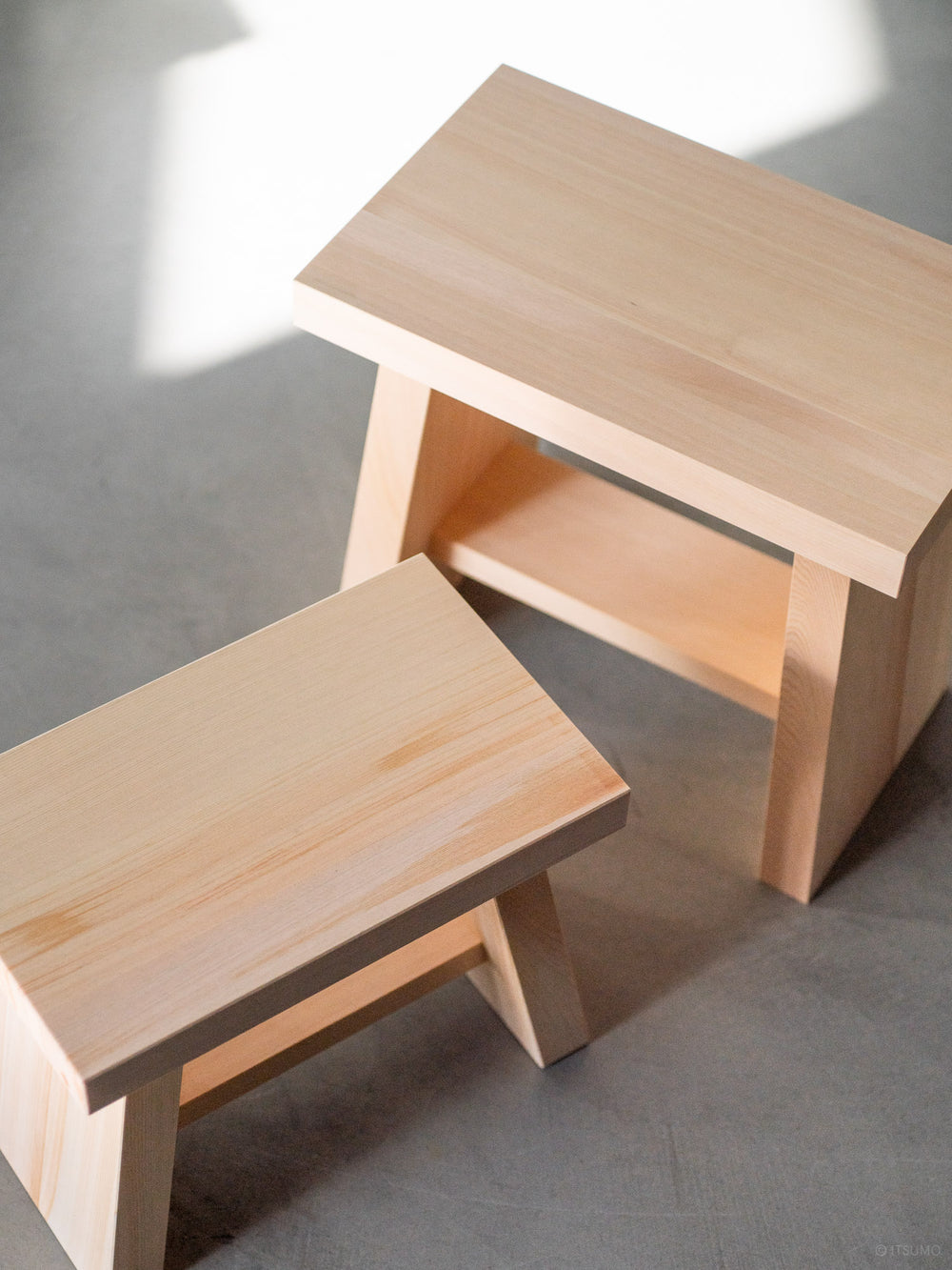 Two Azmaya hinoki bath stools handcrafted in Japan using sustainable Japanese cypress