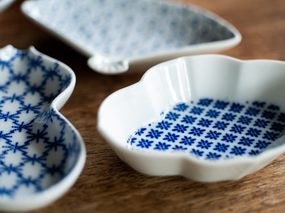 Close up of Azmaya small white dishes with a textured blue pattern inside