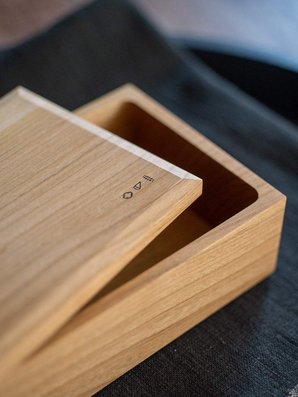 Close up detail with angled lid edge of Azmaya's butter case made of wild cherry wood