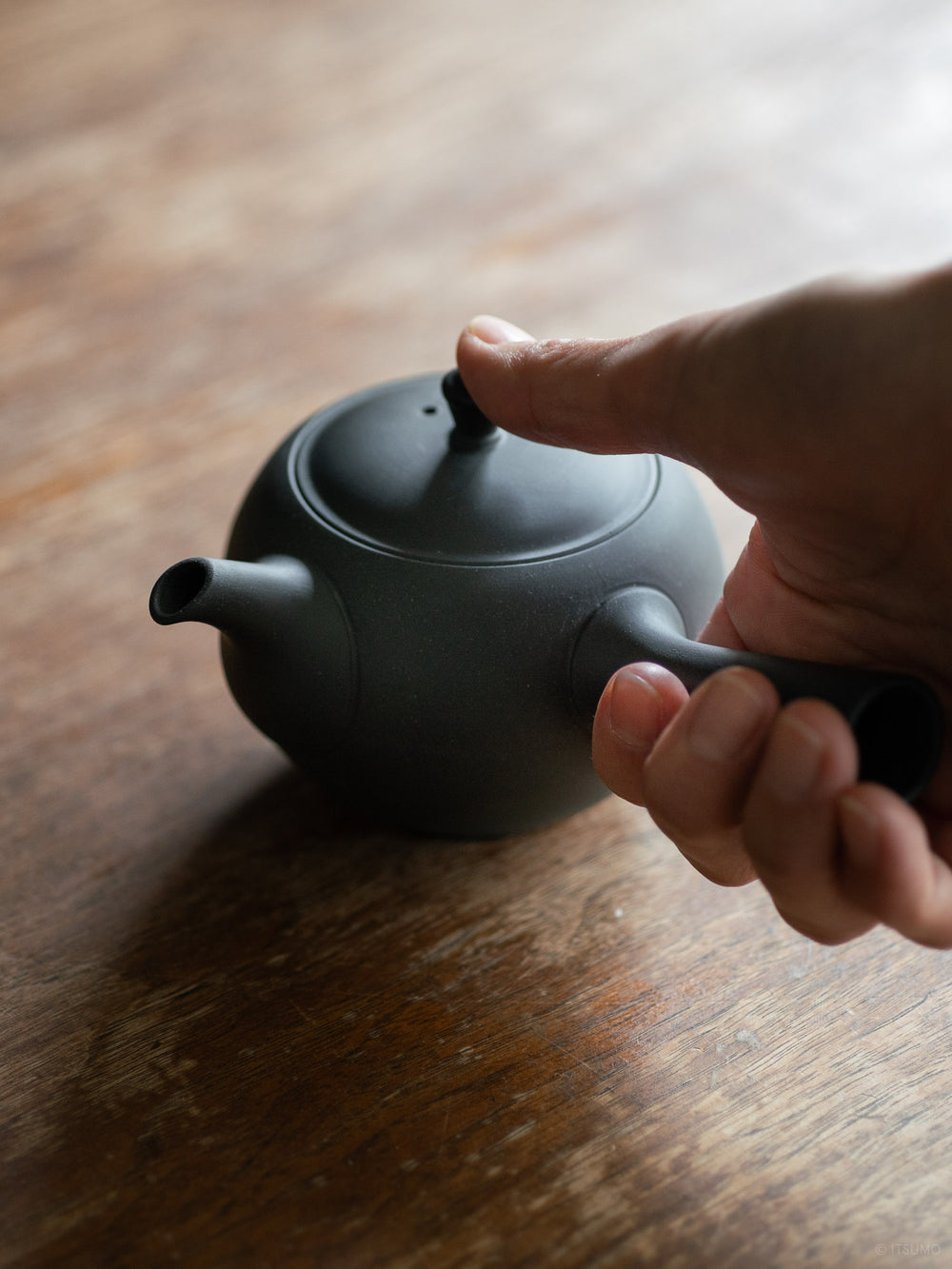 Azmaya ceramic round teapot in unglazed matte black with side handle