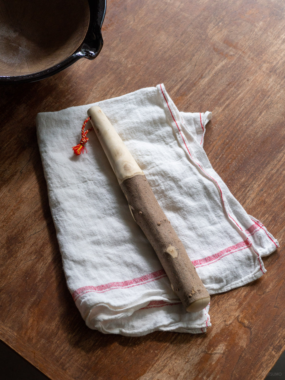 Azmaya extra large sansho wood pestle on a linen kitchen cloth