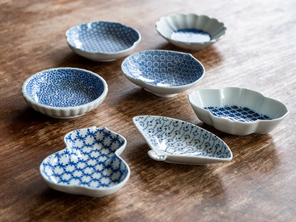 Six small Azmaya white porcelain dishes with a blue pattern inside in various shapes