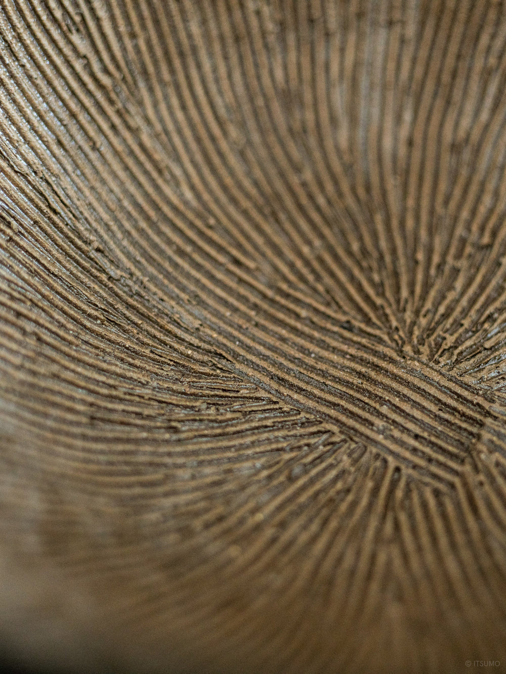 Close up detail of the inside of iga suribachi mortar showing textured lines in ceramic clay