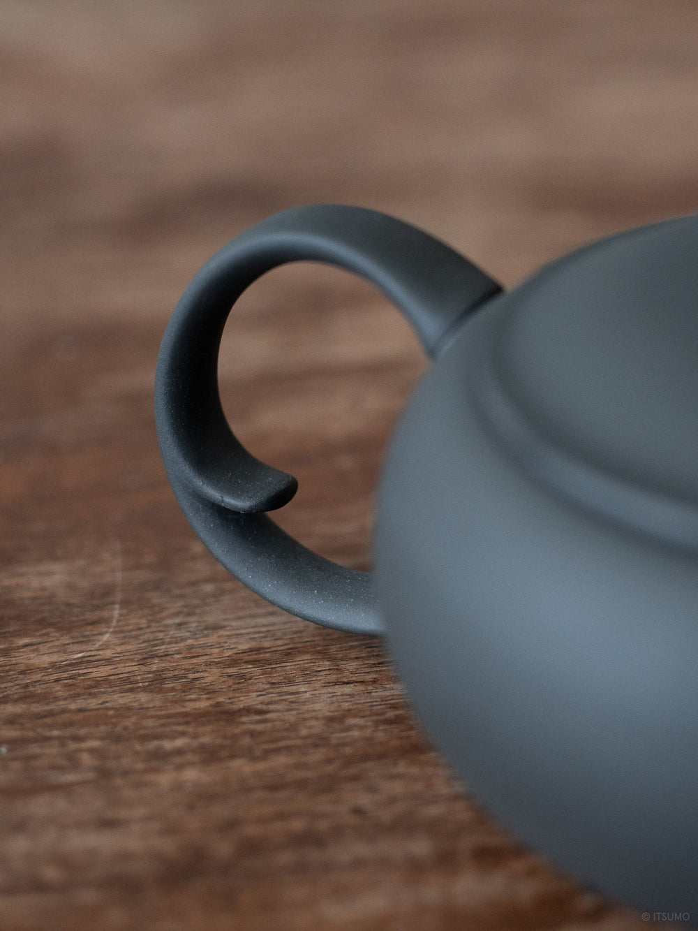 Azmaya’s oval teapot in unglazed in matte black ceramic with a round back handle