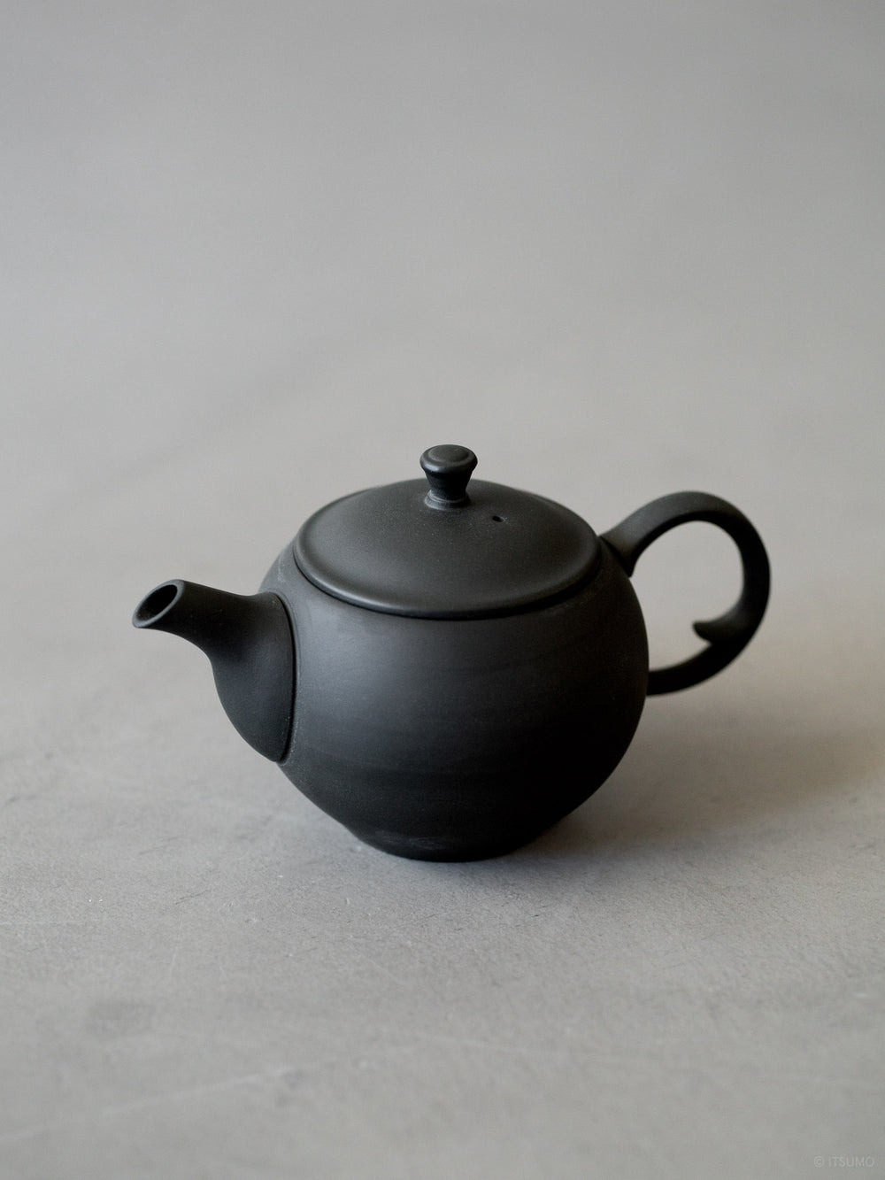 Azmaya round ceramic teapot with back handle in unglazed matte black